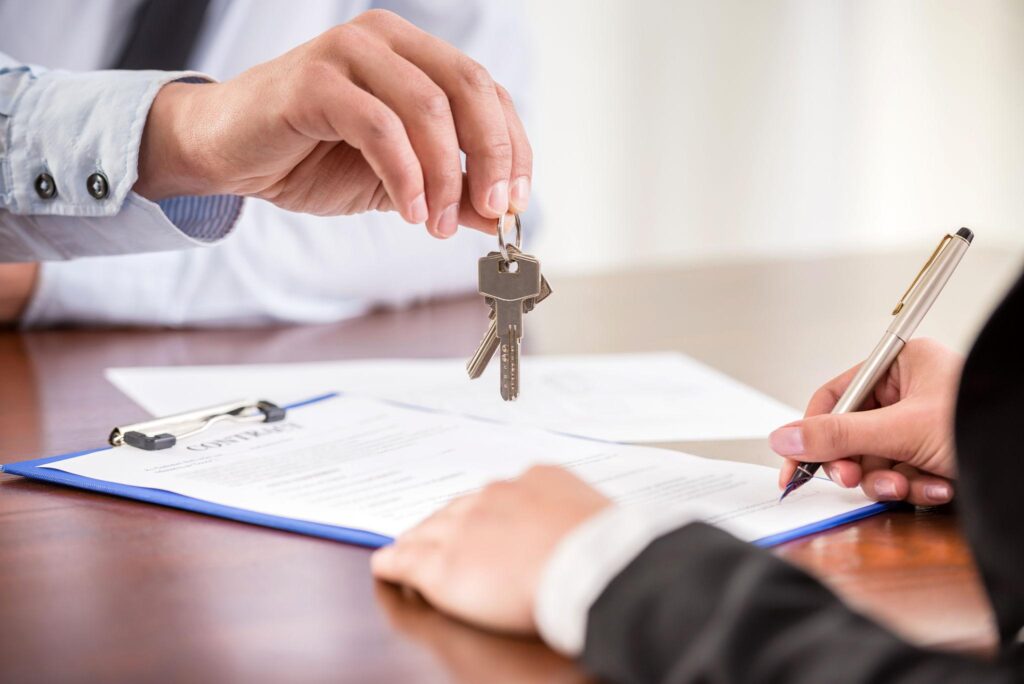 Man handing keys to a homeowner- closed cash deal
