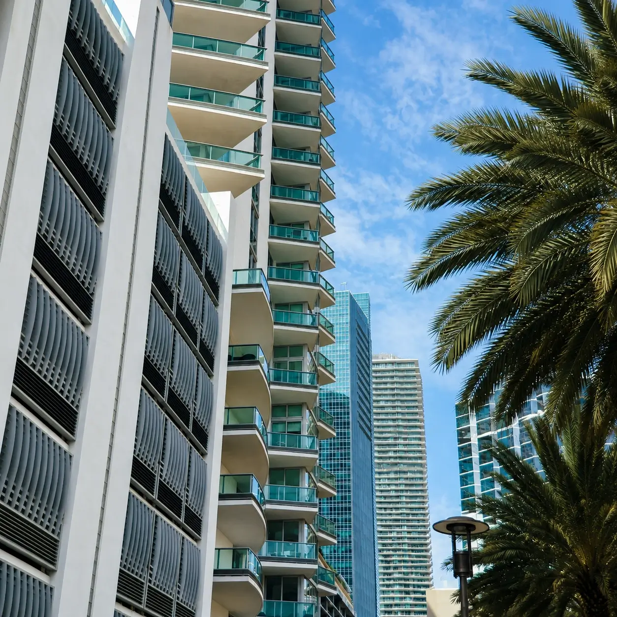 Large Tall apartment buildings featuring glass balconies, with palm tree view, in Grand Palms, Pembroke Pines, fl