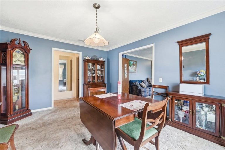 living room with blue walls and a brown table in East Heron, FL