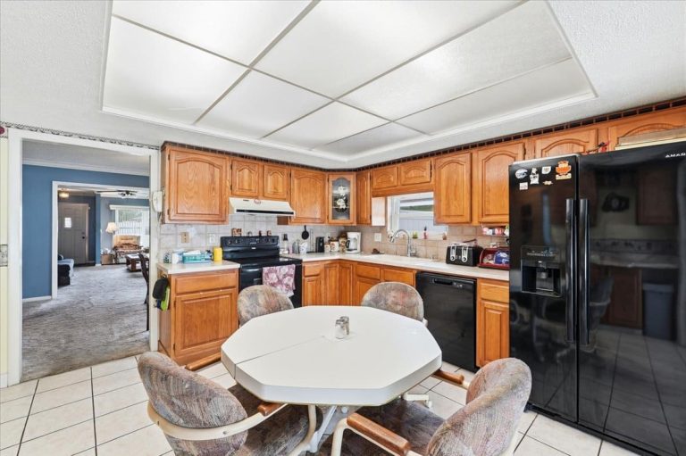 Kitchen featuring brown cabinets, white countertops and a round table