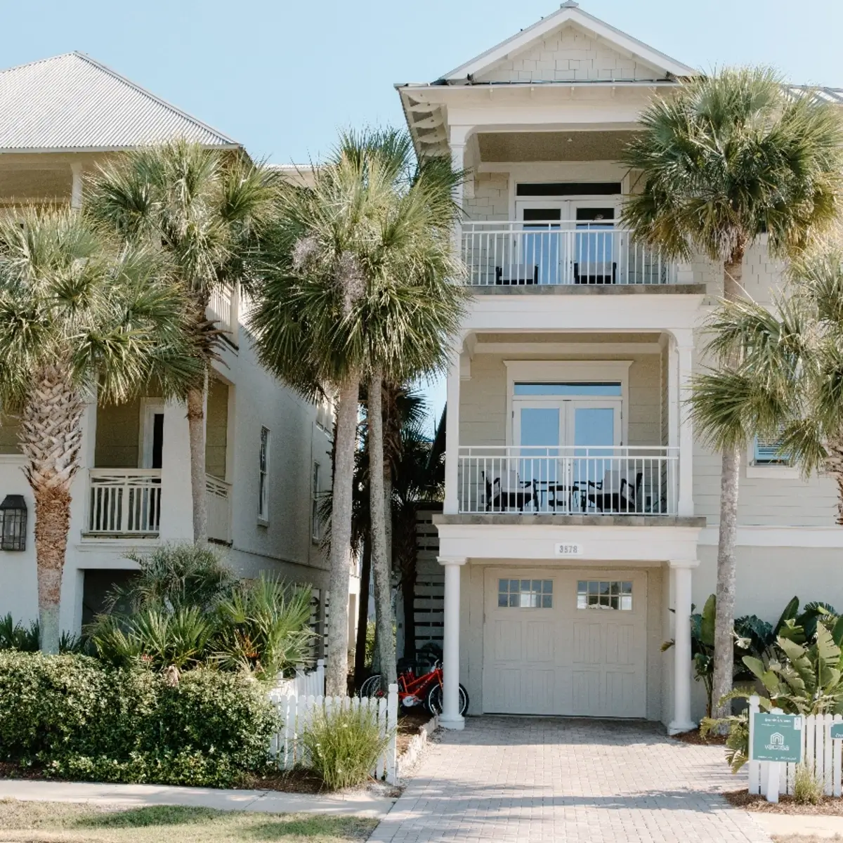 Three-story home with palm trees and balconies in Downtown Leesburg