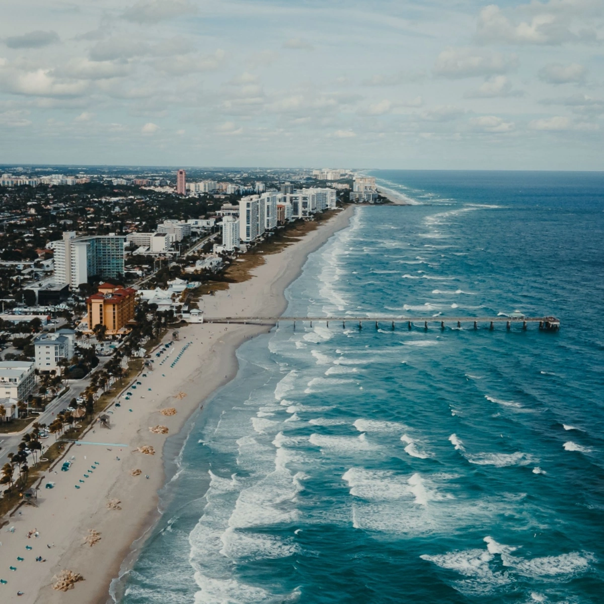 Aerial view of beachfront high-rises and pier near Fair Gate, North Lauderdale