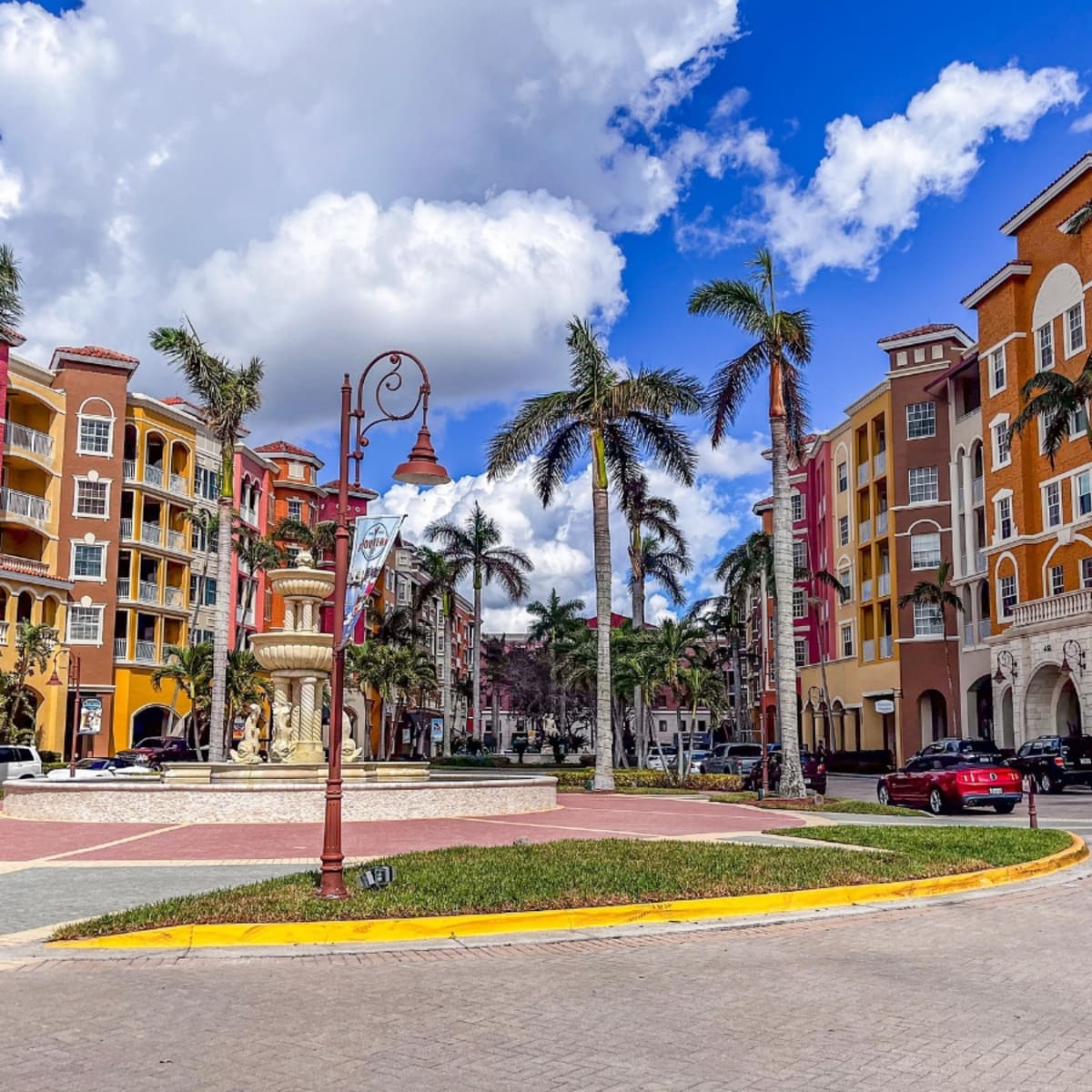 Colorful Mediterranean-style plaza with fountain and palm trees in Lauderdale Oaks