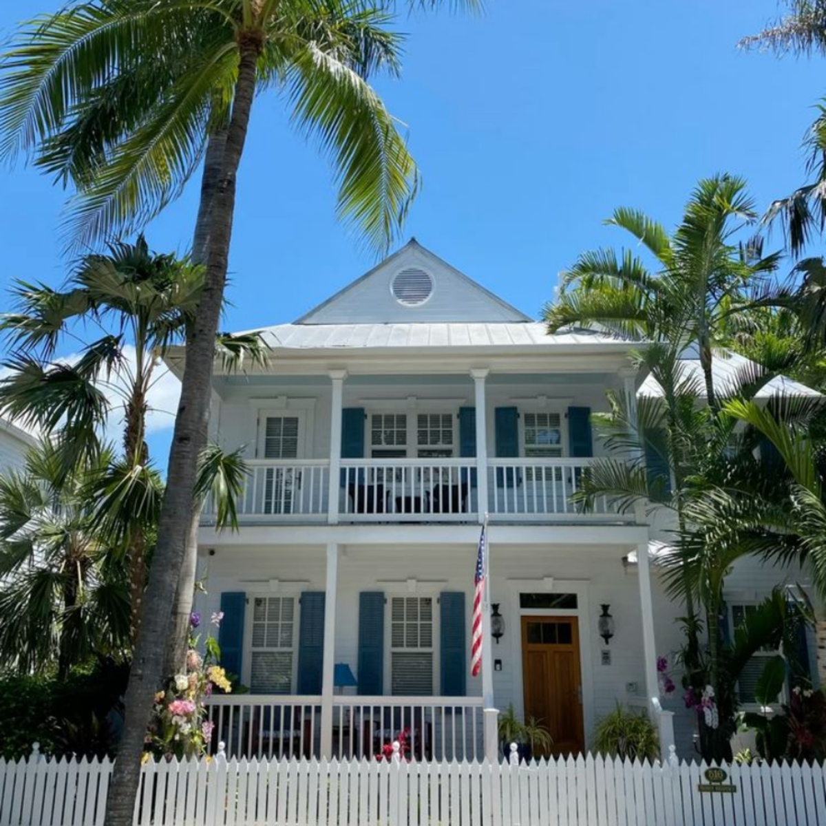 Two-story white Key West-style home with wraparound porches in Mariner Village, Stuart