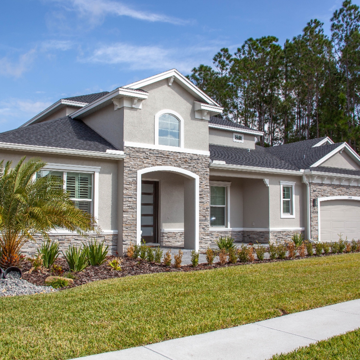 Modern stucco single-family home with stone accents in Mizner Park, Boca Raton