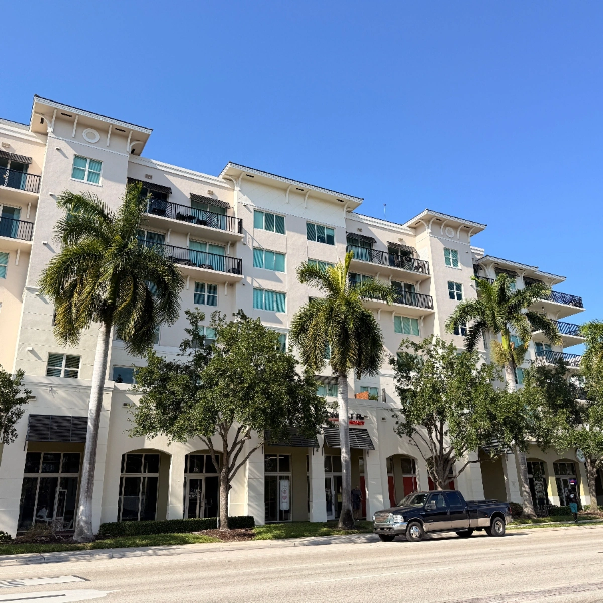 Multi-story condo building with ground-floor shops in North Lauderdale Estates