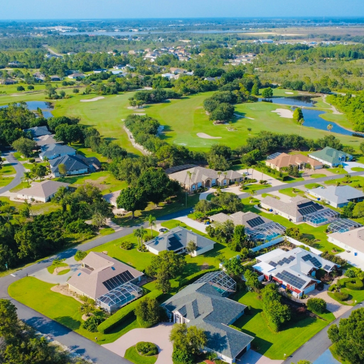 Aerial view of single-family homes bordering a golf course in North Lauderdale Village