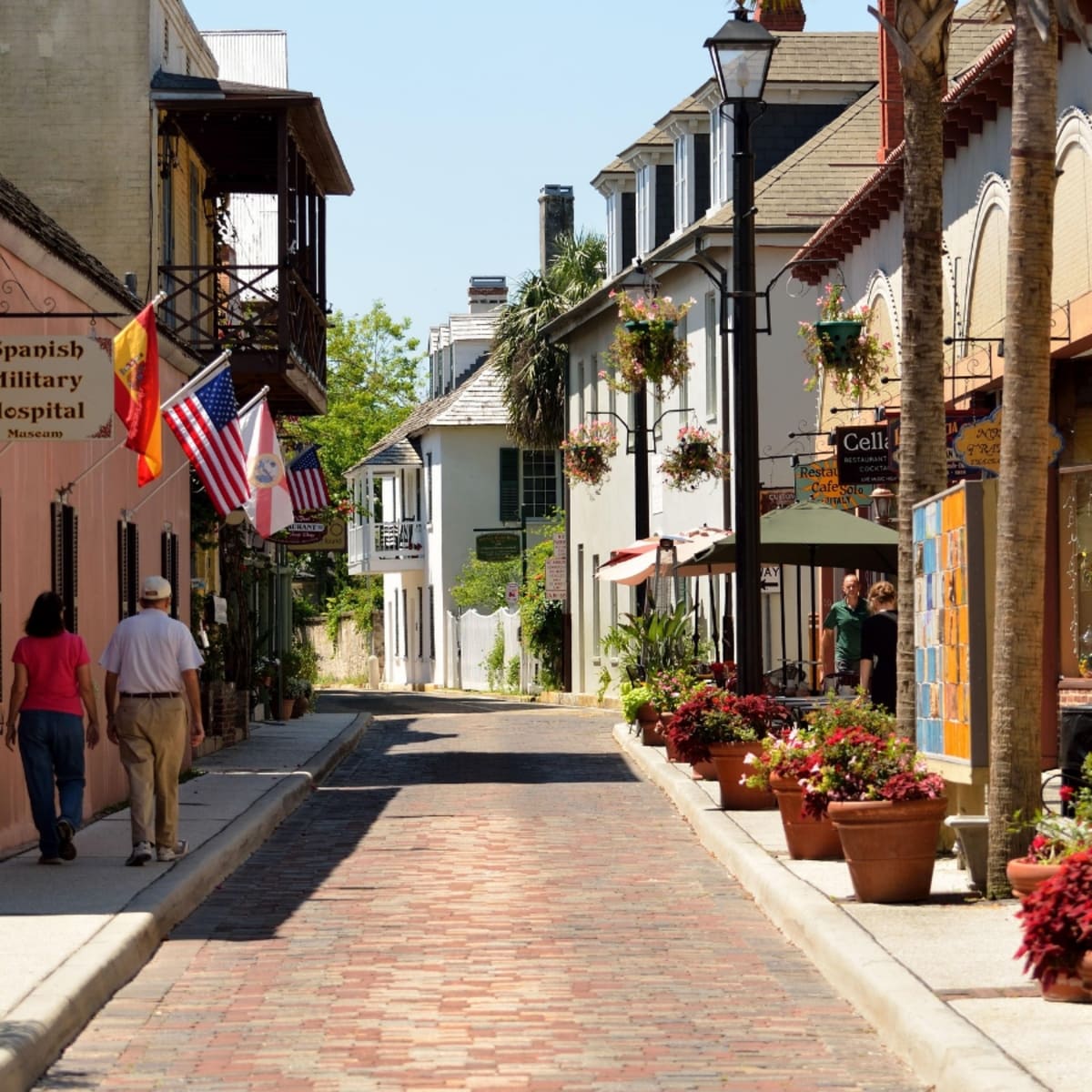 Historic brick street with colonial buildings and flags in Oakland Estates, Lauderdale Lakes