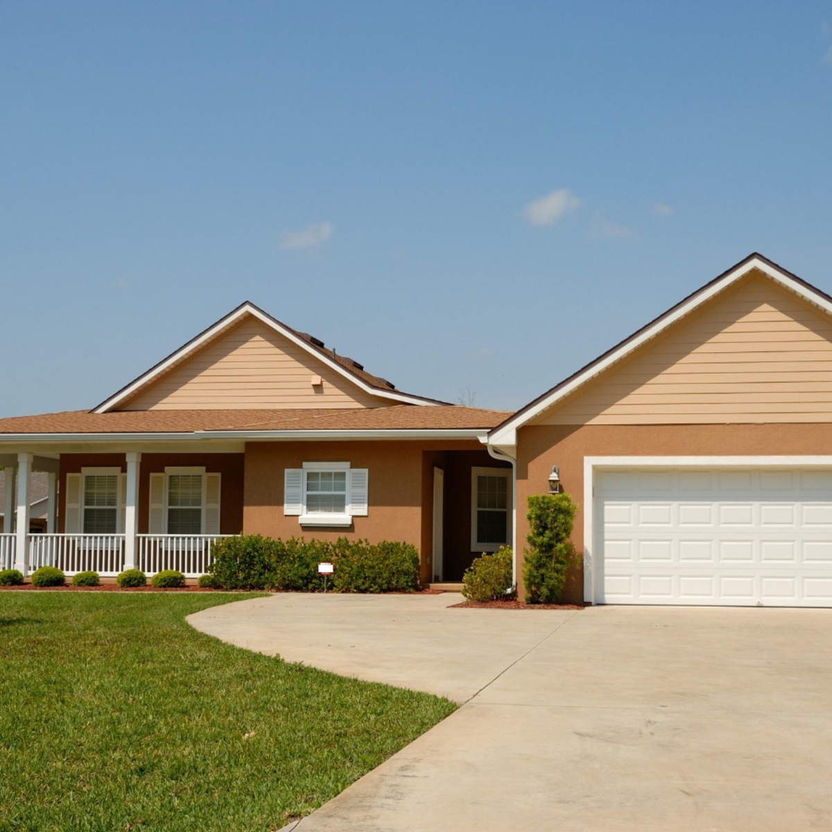 Single-story ranch home with wraparound porch and two-car garage in Old Floresta, Boca Raton.