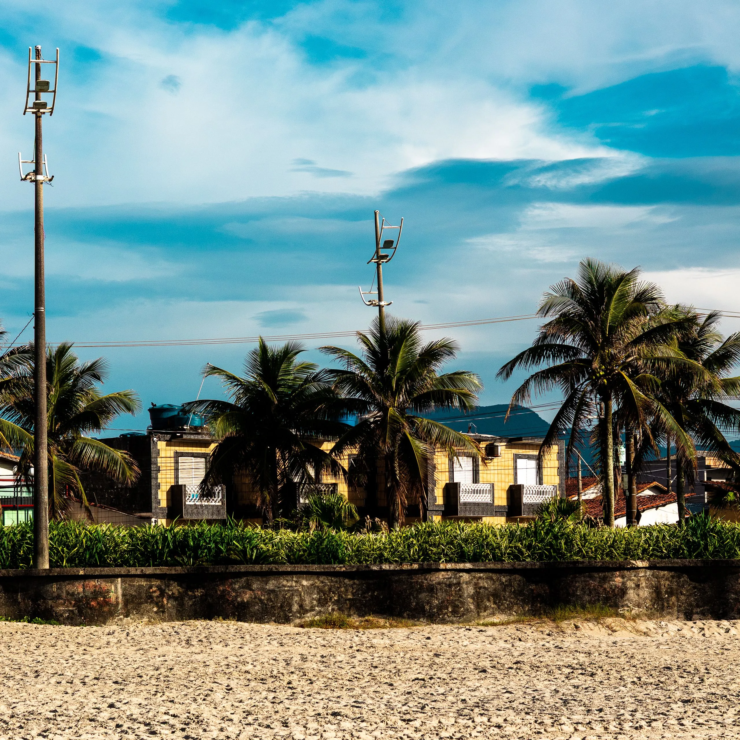 Beachfront view near Shenandoah, Davie, FL, with palm trees and tiled houses along the shoreline.