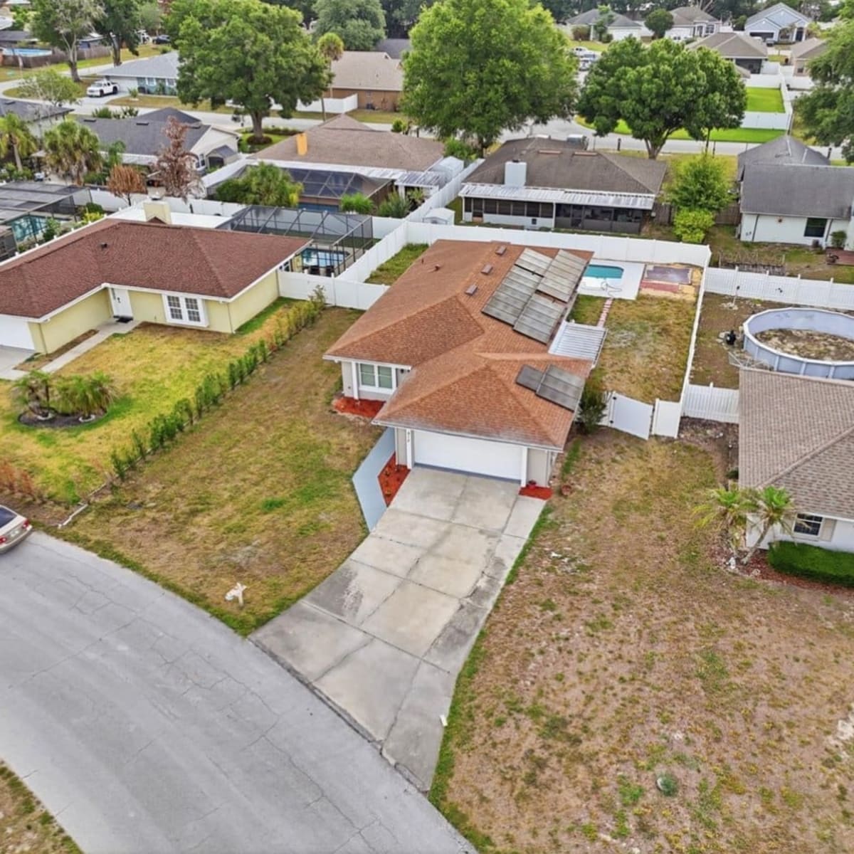 Aerial view of single-family homes with pools in The Acreage, Loxahatchee