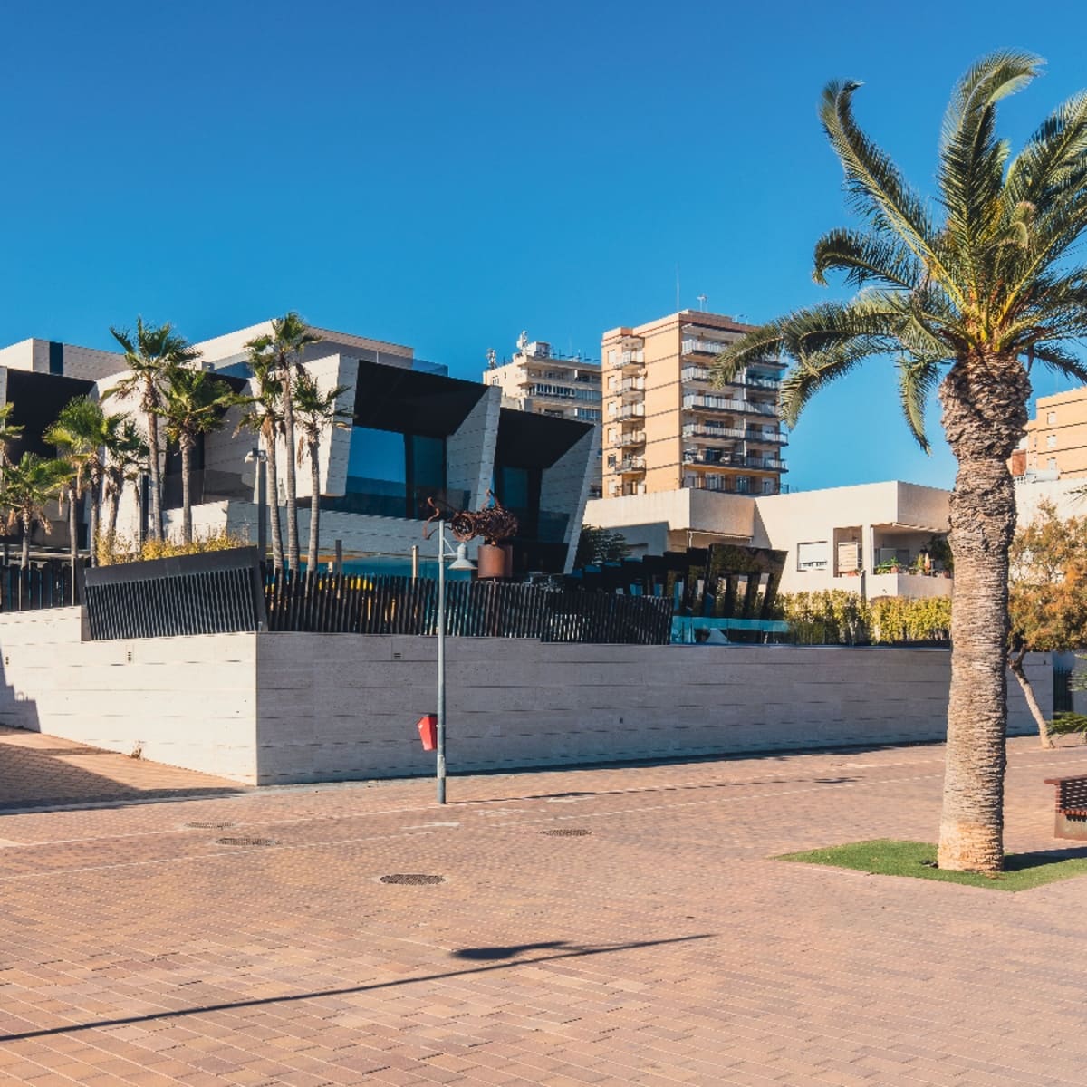 Modern waterfront building with palm trees on a plaza in The Moorings, Vero Beach